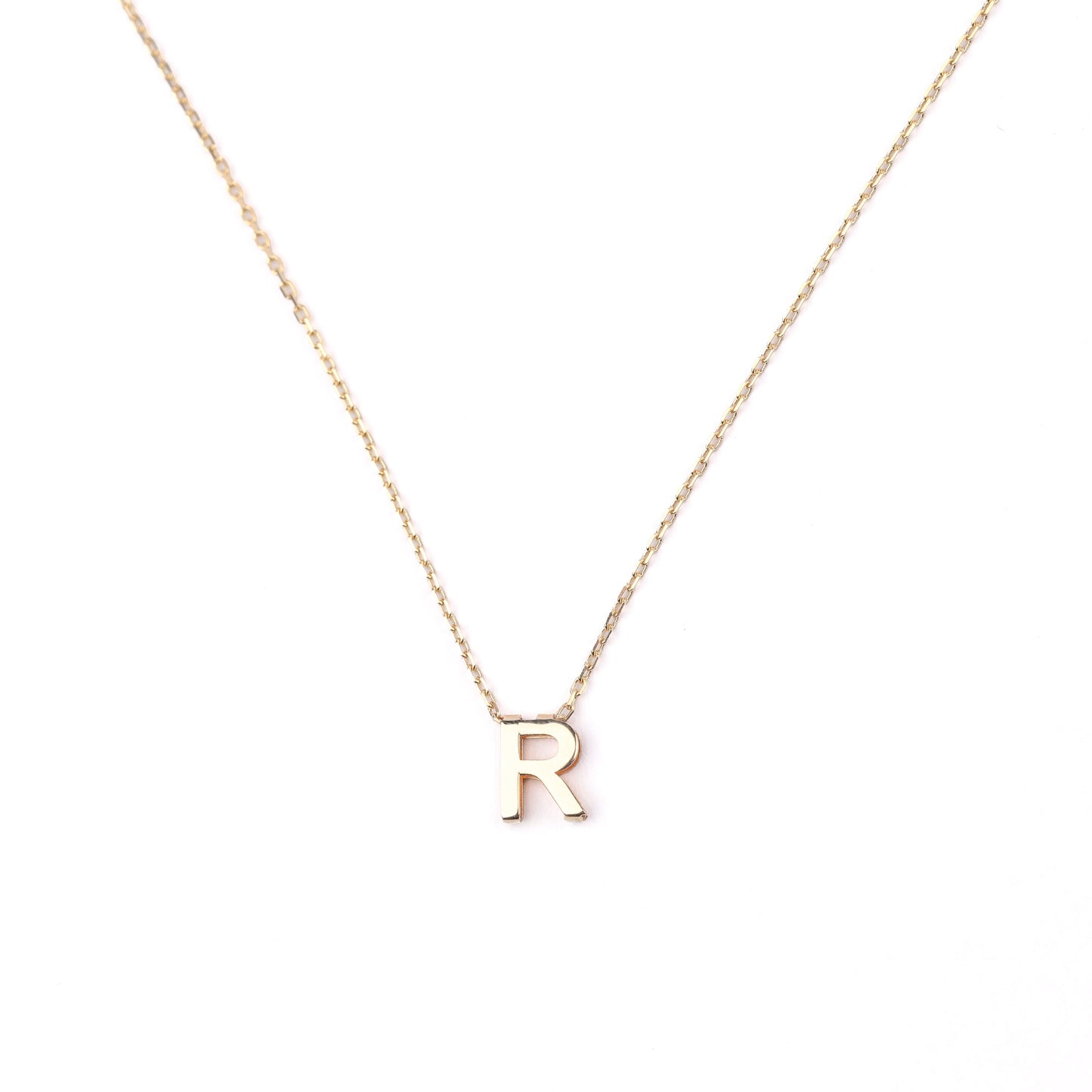 women's solid gold necklace with an 'R' pendant on a white background